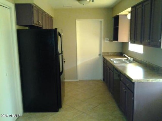 kitchen with sink and black refrigerator