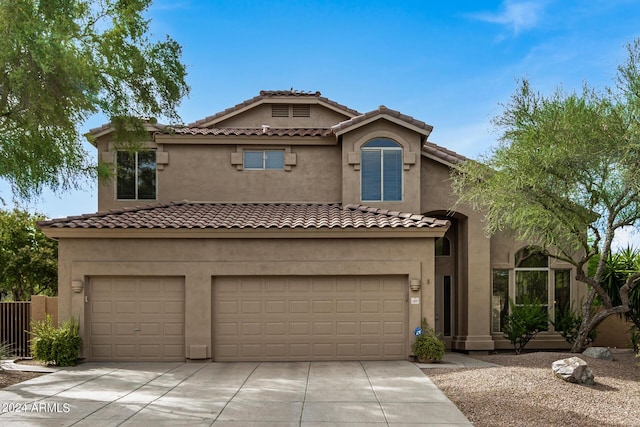 mediterranean / spanish-style home with a garage