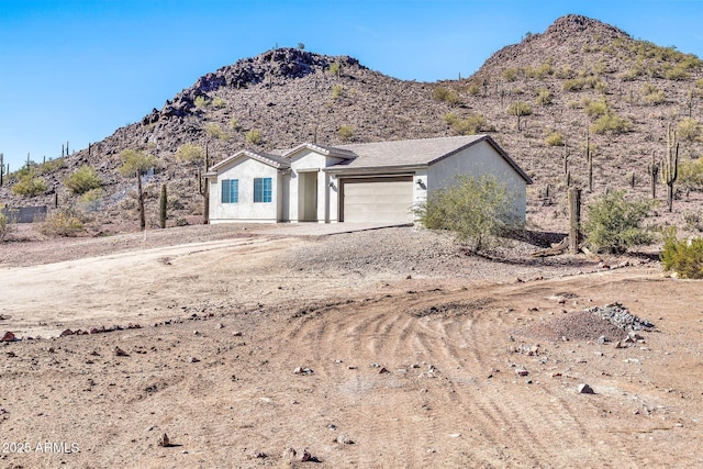 ranch-style house with a mountain view and a garage