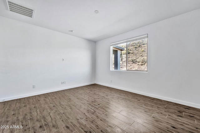 spare room featuring dark hardwood / wood-style flooring