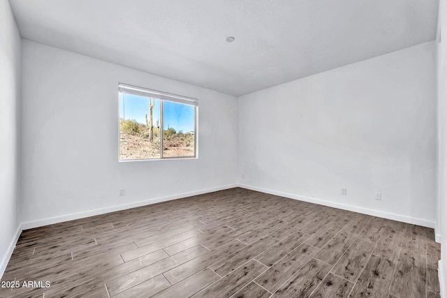 empty room with hardwood / wood-style flooring