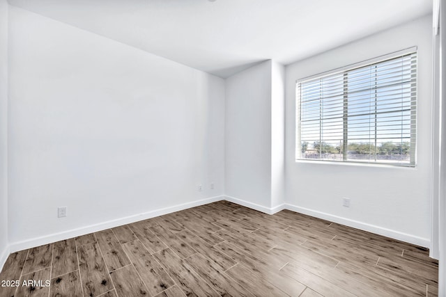 empty room with hardwood / wood-style floors