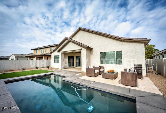 rear view of house featuring a fenced in pool and a patio area