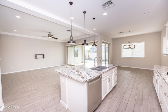 kitchen featuring dishwasher, a center island with sink, white cabinetry, and sink