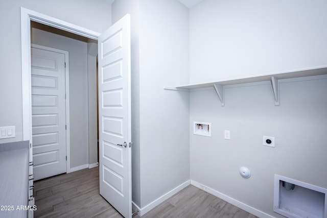 laundry room with hookup for an electric dryer, hookup for a washing machine, light hardwood / wood-style flooring, and gas dryer hookup