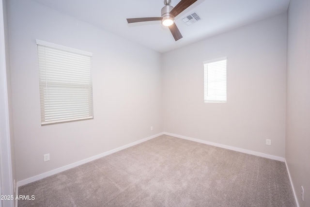 carpeted spare room featuring ceiling fan