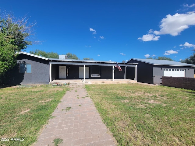 ranch-style house with a garage and a front lawn