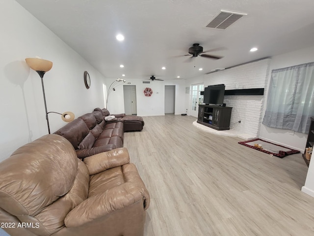 living room featuring ceiling fan and light hardwood / wood-style flooring