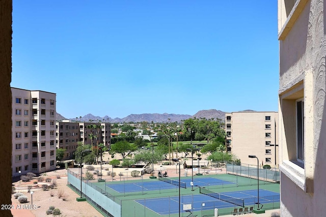 view of tennis court featuring a mountain view