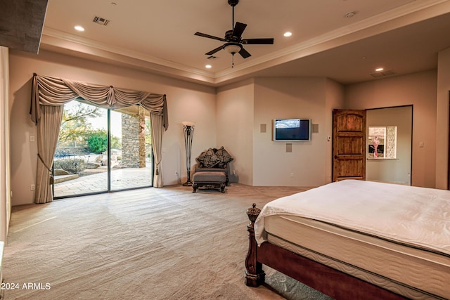 carpeted bedroom with a tray ceiling, access to outside, and ornamental molding