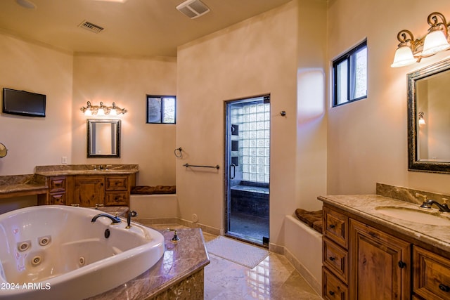 bathroom featuring independent shower and bath and vanity