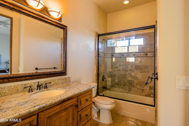 full bathroom with vanity, shower / bath combination with glass door, and toilet