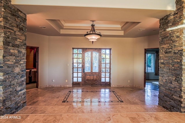 entryway featuring crown molding and a tray ceiling