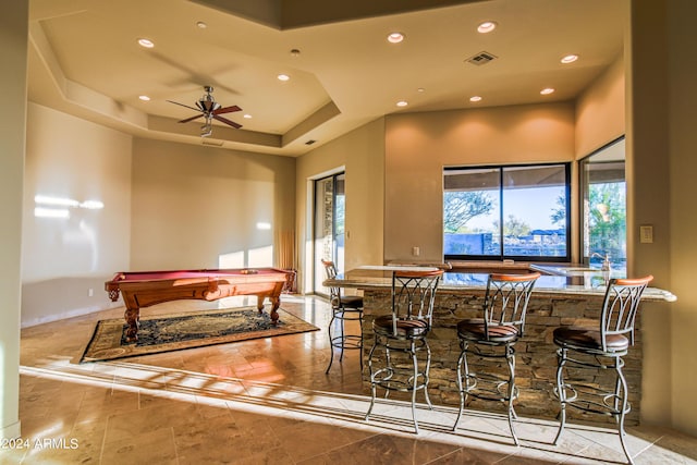 dining area with a tray ceiling, ceiling fan, and billiards