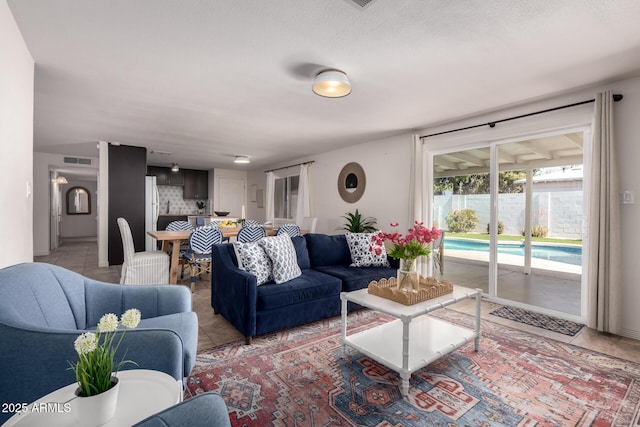 living area featuring visible vents and light tile patterned floors