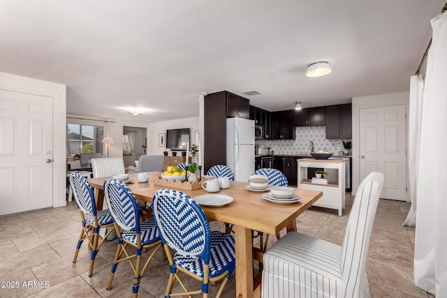 dining room featuring visible vents and light tile patterned flooring