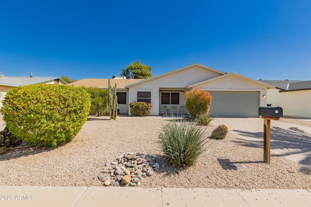 ranch-style home featuring concrete driveway and an attached garage