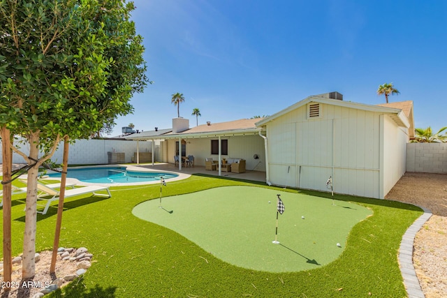 back of house featuring a patio, a fenced backyard, and a fenced in pool