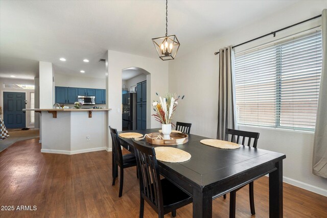 dining space featuring recessed lighting, dark wood-type flooring, baseboards, a chandelier, and arched walkways