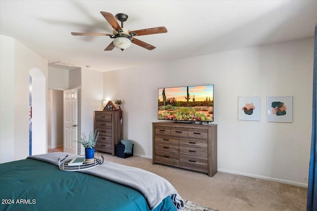 carpeted bedroom featuring baseboards and ceiling fan
