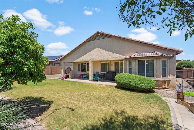 back of property featuring a patio, stucco siding, a fenced backyard, and a yard