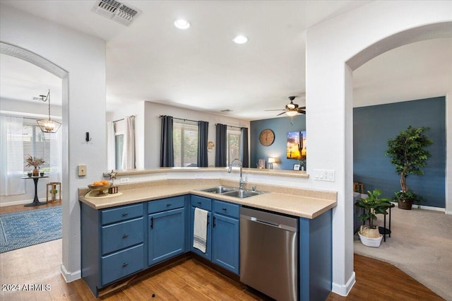 kitchen with dishwasher, arched walkways, a sink, a healthy amount of sunlight, and blue cabinets