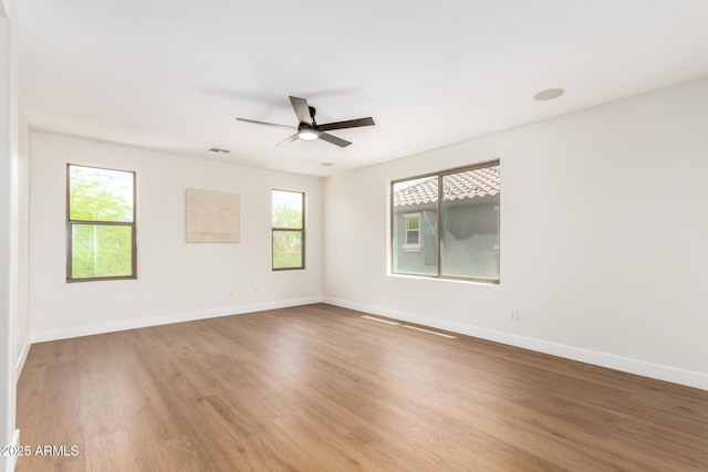 11891 N 147th Dr, Surprise, AZ 85379 - empty room with a ceiling fan, baseboards, visible vents, and wood finished floors