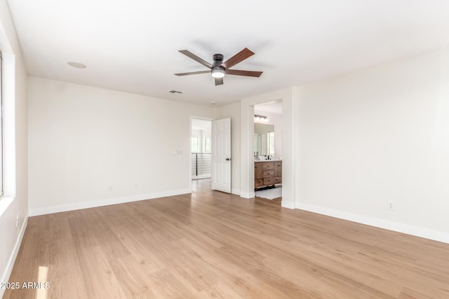 11891 N 147th Dr, Surprise, AZ 85379 - unfurnished living room with a ceiling fan, baseboards, light wood-style flooring, and visible vents