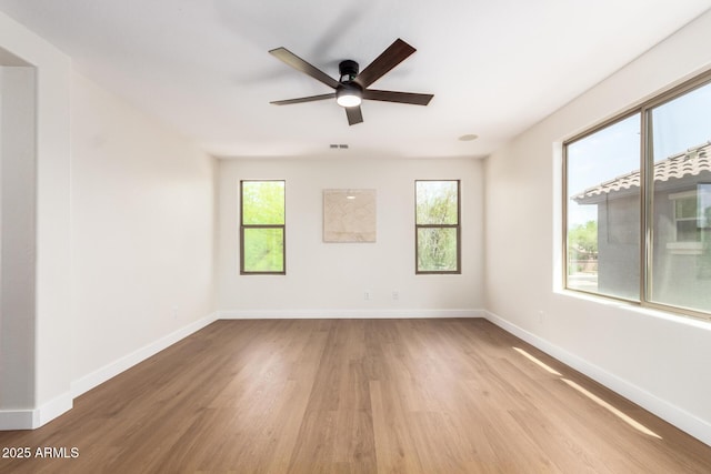 11891 N 147th Dr, Surprise, AZ 85379 - empty room with baseboards, ceiling fan, plenty of natural light, and wood finished floors