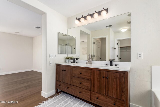 11891 N 147th Dr, Surprise, AZ 85379 - bathroom featuring a sink, baseboards, visible vents, and wood finished floors