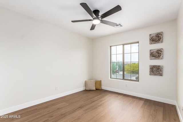 11891 N 147th Dr, Surprise, AZ 85379 - spare room featuring ceiling fan, baseboards, visible vents, and wood finished floors