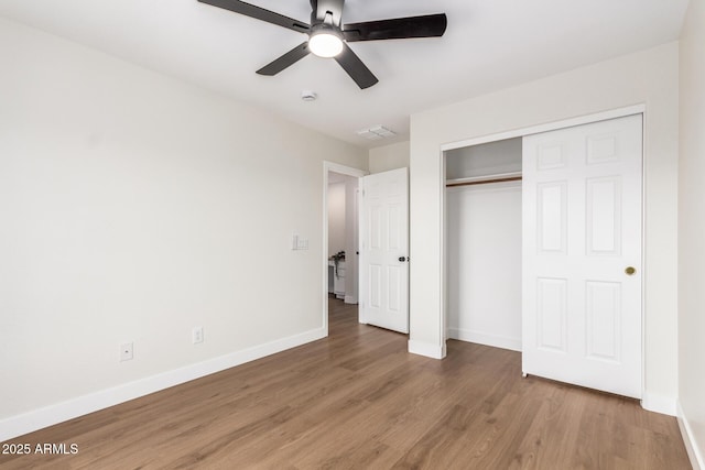 11891 N 147th Dr, Surprise, AZ 85379 - unfurnished bedroom featuring a closet, light wood-type flooring, baseboards, and ceiling fan