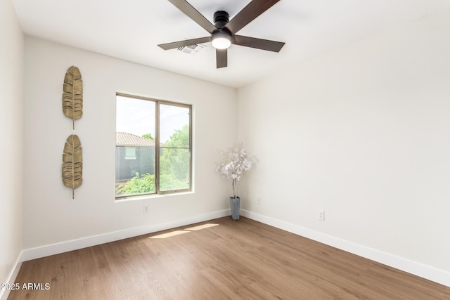 11891 N 147th Dr, Surprise, AZ 85379 - empty room featuring wood finished floors, visible vents, baseboards, and a ceiling fan