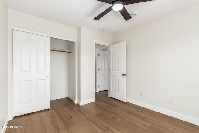 11891 N 147th Dr, Surprise, AZ 85379 - unfurnished bedroom with baseboards, a closet, a ceiling fan, and wood finished floors