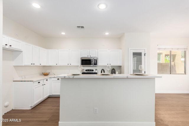 11891 N 147th Dr, Surprise, AZ 85379 - kitchen with visible vents, light wood-style flooring, appliances with stainless steel finishes, and white cabinets