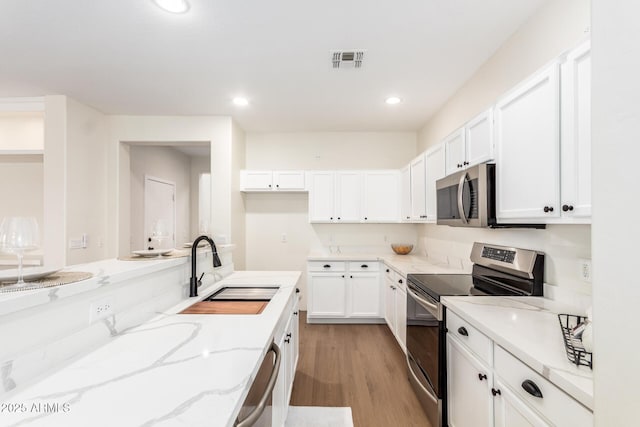 11891 N 147th Dr, Surprise, AZ 85379 - kitchen with light wood-style flooring, visible vents, a sink, white cabinets, and appliances with stainless steel finishes