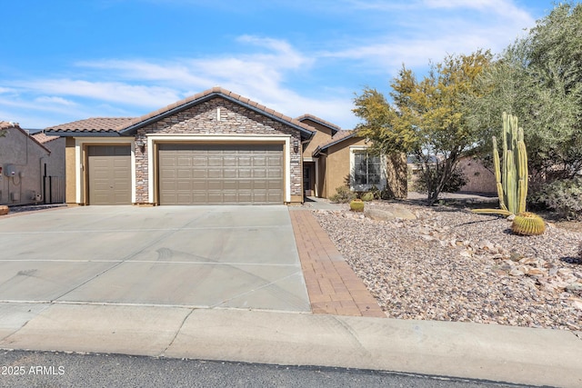 single story home with an attached garage, a tile roof, concrete driveway, stone siding, and stucco siding