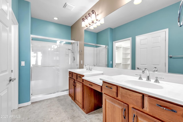 bathroom featuring a shower stall, visible vents, and a sink