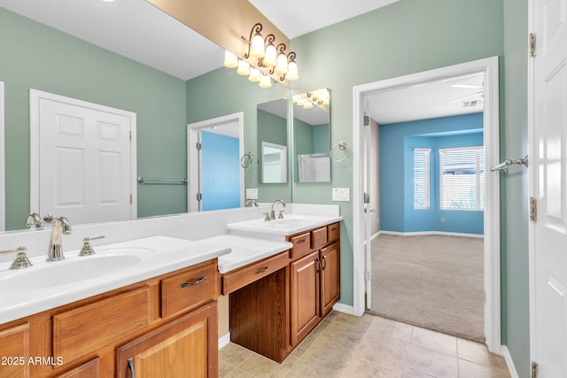 full bathroom with tile patterned flooring, a sink, baseboards, and double vanity