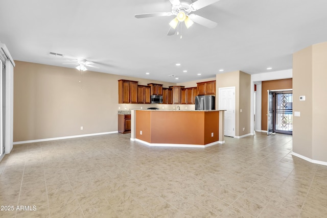 kitchen with visible vents, stainless steel appliances, a ceiling fan, and open floor plan