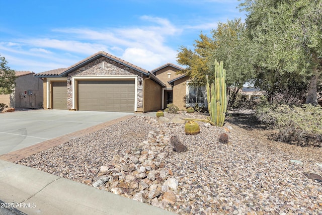 single story home with an attached garage, stone siding, a tiled roof, driveway, and stucco siding