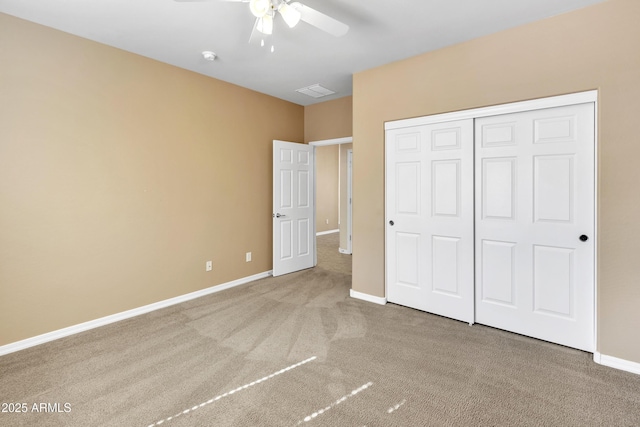 unfurnished bedroom featuring visible vents, baseboards, ceiling fan, carpet, and a closet