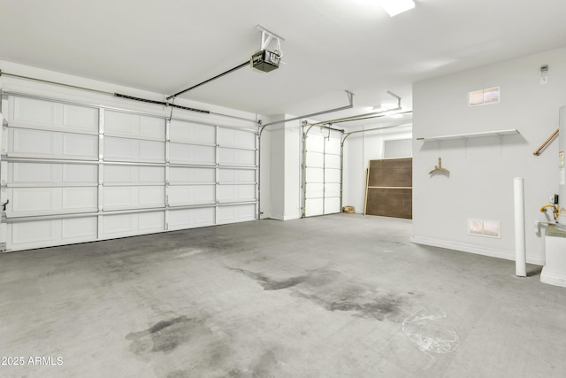 garage with a garage door opener and baseboards