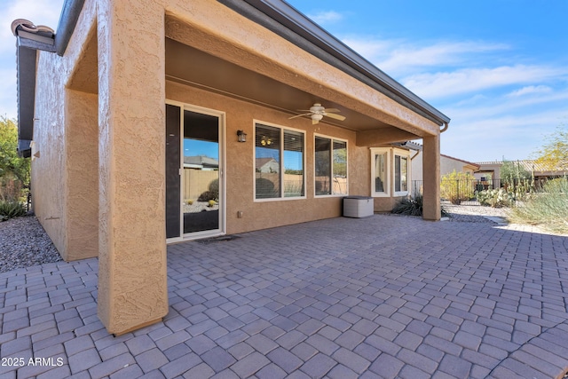 view of patio featuring a ceiling fan and fence