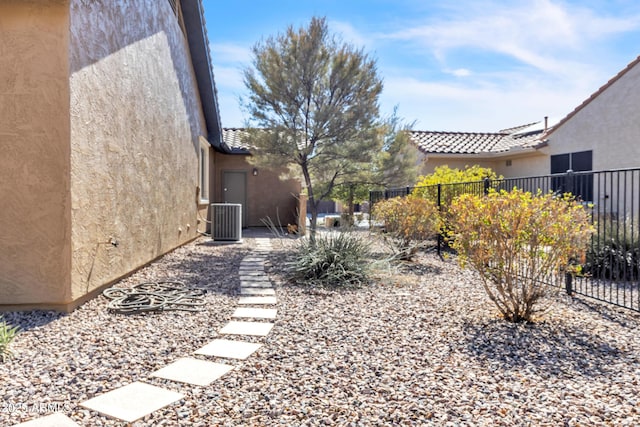 view of yard with cooling unit and fence