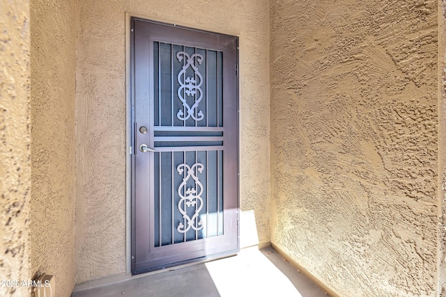 view of exterior entry featuring stucco siding