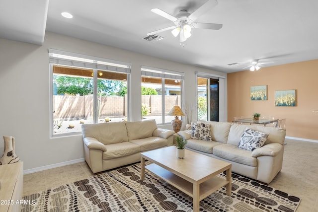 living room featuring light tile patterned floors, a ceiling fan, and visible vents