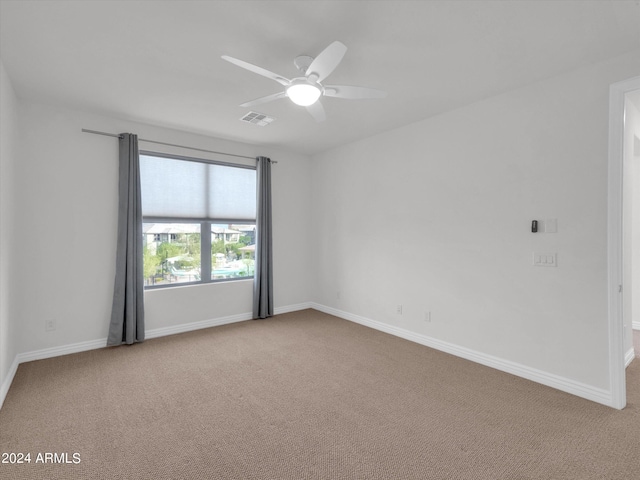 carpeted empty room featuring ceiling fan