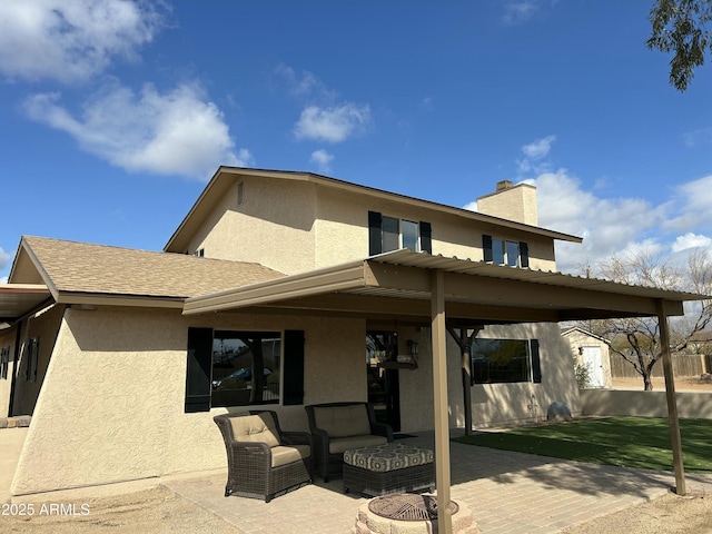 back of property featuring a patio and an outdoor hangout area