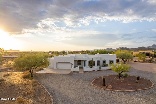 36382 N 35th St, Cave Creek, AZ 85331 - pueblo-style home featuring a garage, a mountain view, stucco siding, and curved driveway